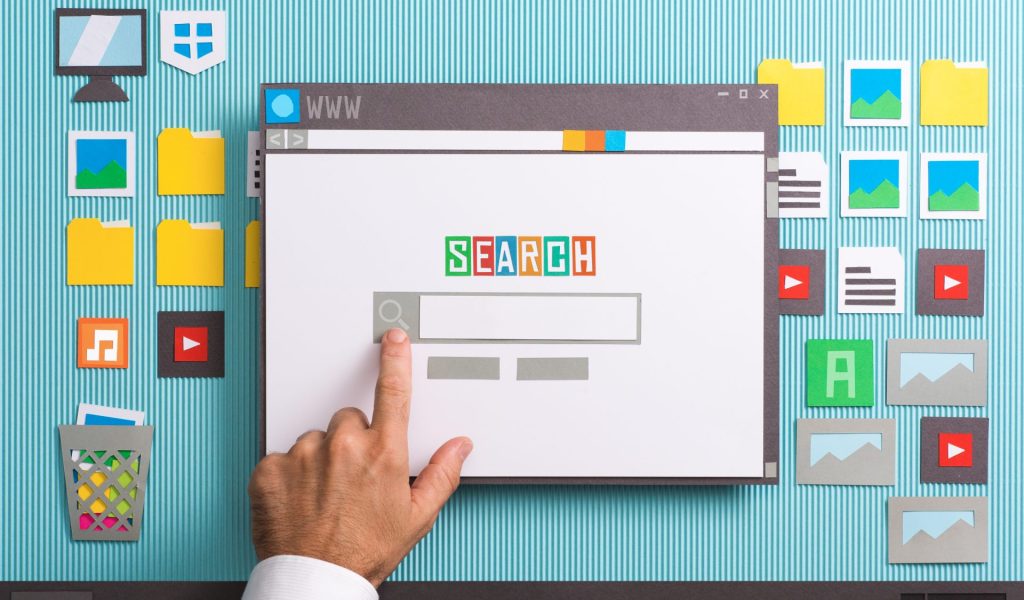 Search engine home page with search bar on a browser window, a user is entering a query, collage and paper cut composition